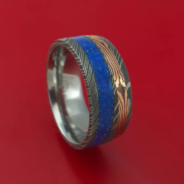 Damascus Steel Band with 14k Rose Gold Mokume Shakudo and Lapis Angled Inlays Custom Made Lashbrook Rings Damascus Steel Band with 14k Rose Gold Mokume Shakudo and Lapis Angled Inlays Custom Made Lashbrook Rings