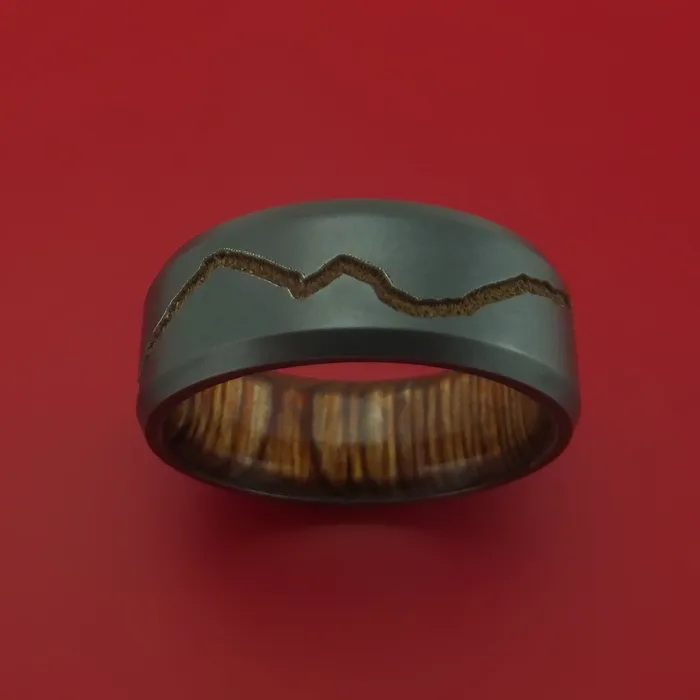 Rings Lashbrook Black Zirconium Ring with GoldToned Milled Mountain Range Design Inlay and Interior Hardwood Sleeve Custom Made Band Rings Lashbrook Black Zirconium Ring with GoldToned Milled Mountain Range Design Inlay and Interior Hardwood Sleeve Custom Made Band